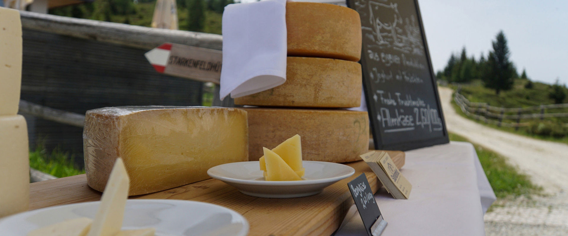 Different types of cheese displayed on a table.