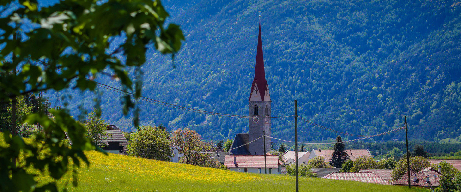 Schabs Parish church of Schabs in summer with green meadows