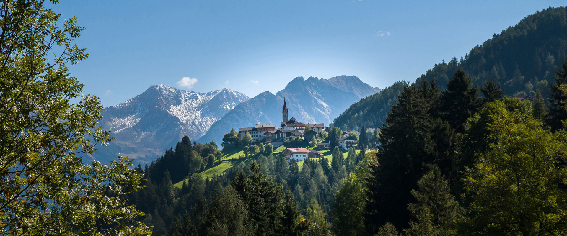 Moos in Passeier Moos in Passeier surrounded by dense forests and rocky mountains.