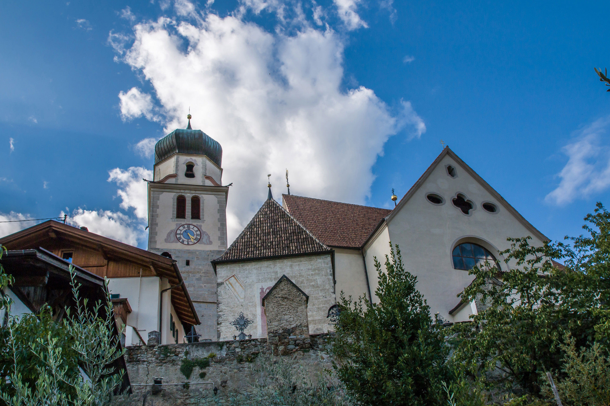 View of the church with steeple from below.