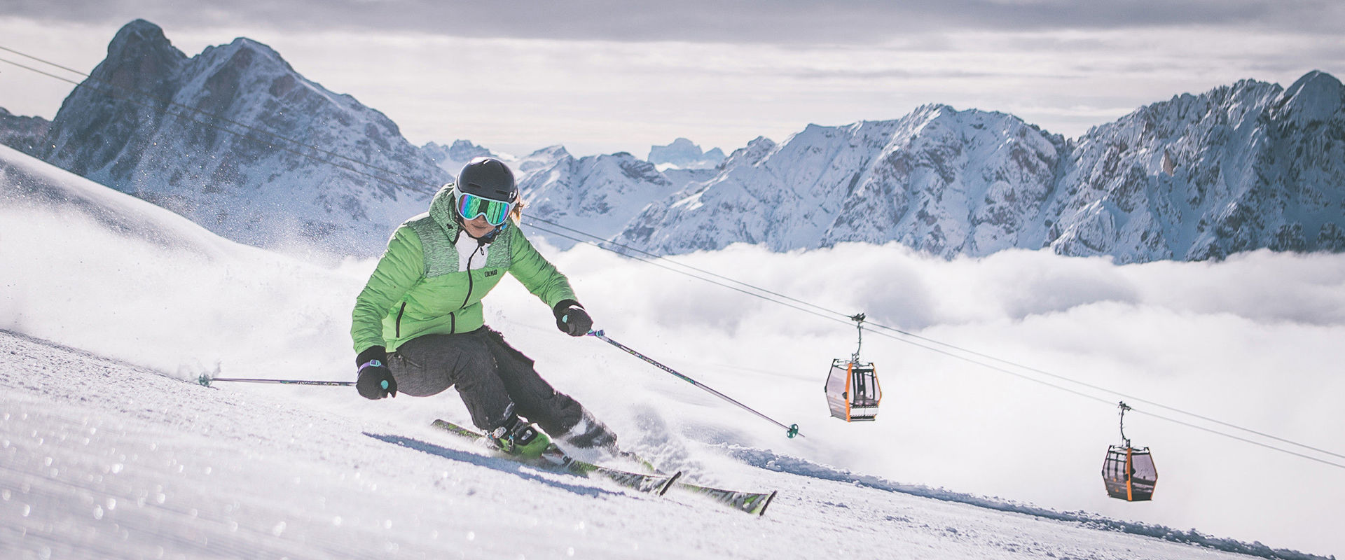 Skiing at Mt. Plose Skier on the slopes of Mt. Plsoe with cable car and Dolomites