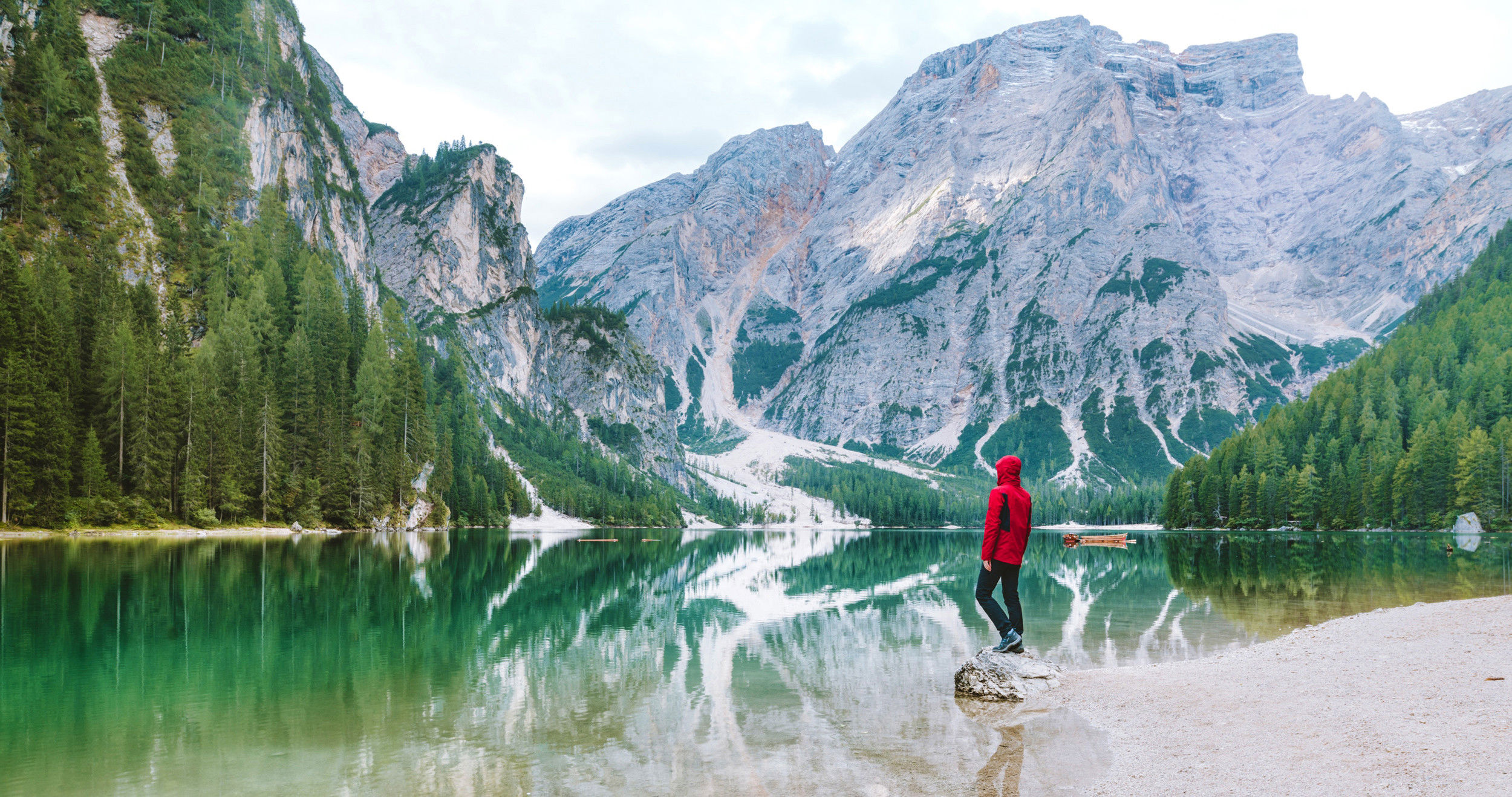 Hiker at Lake Prags with Mt. Seekofel