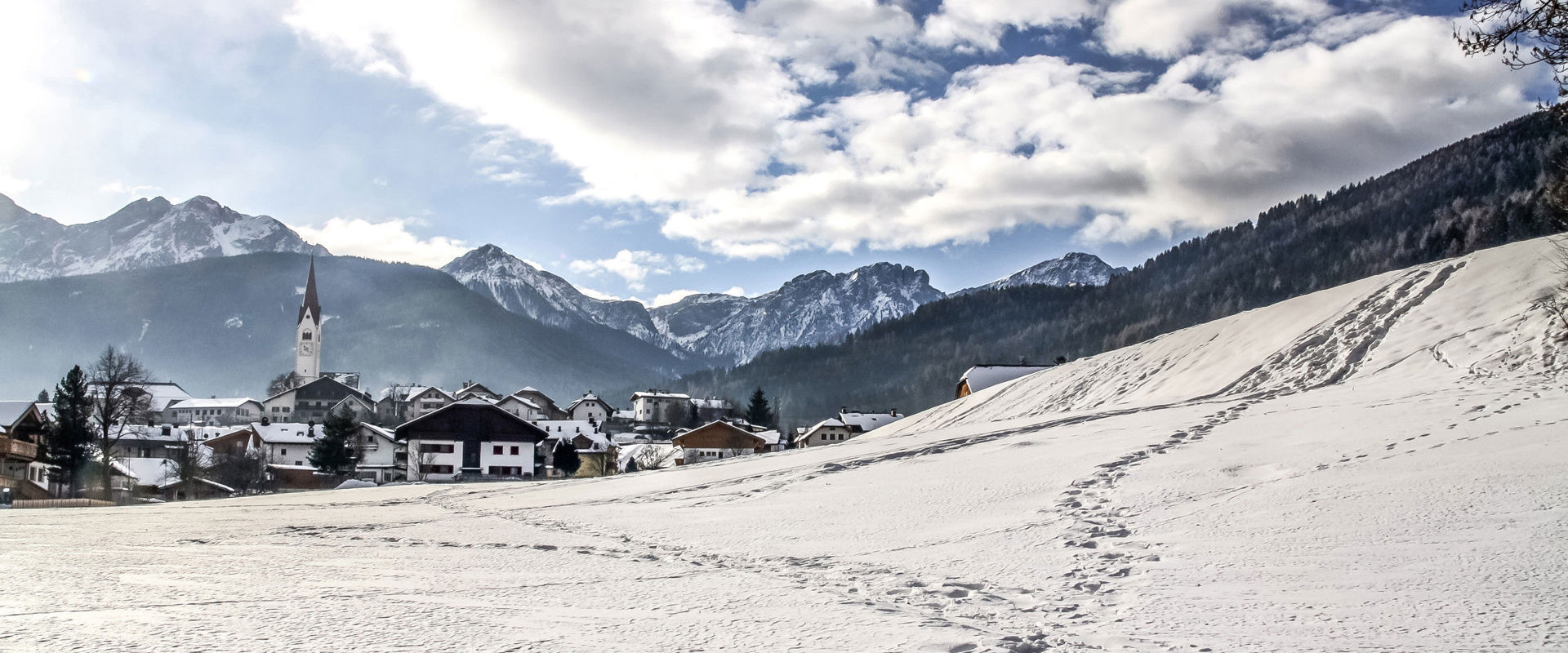 View over Olang with the Dolomites in the background in winter