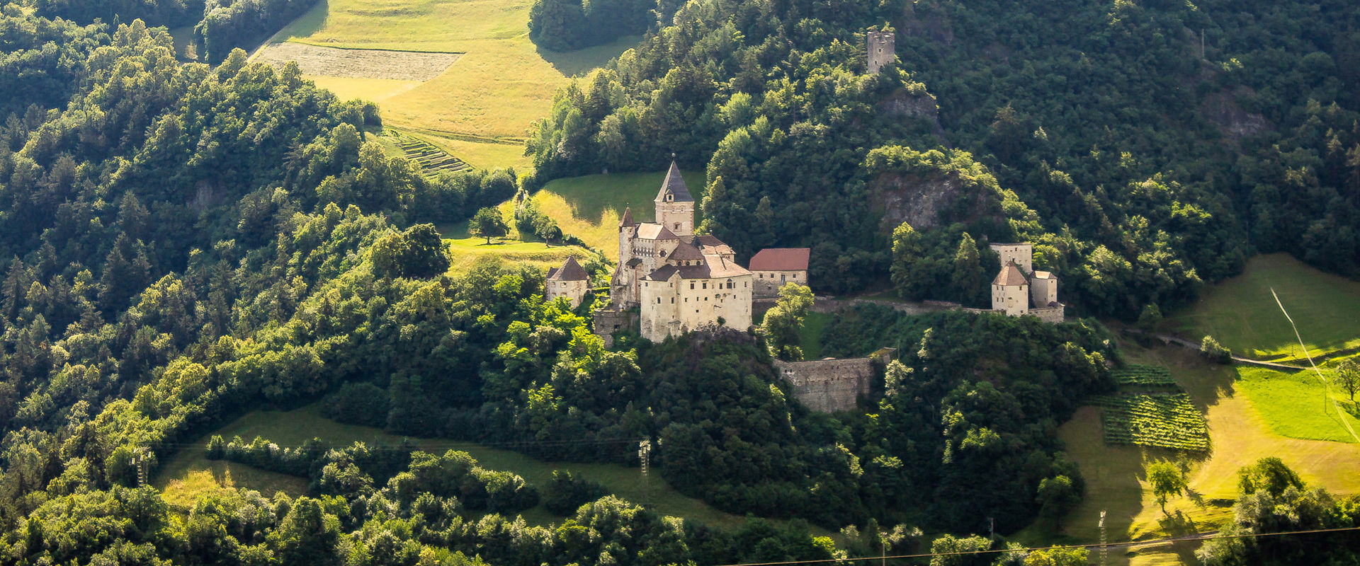 Trostburg Castle Trostburg Castle is enthroned on a slope in the middle of green meadows, fields and trees.