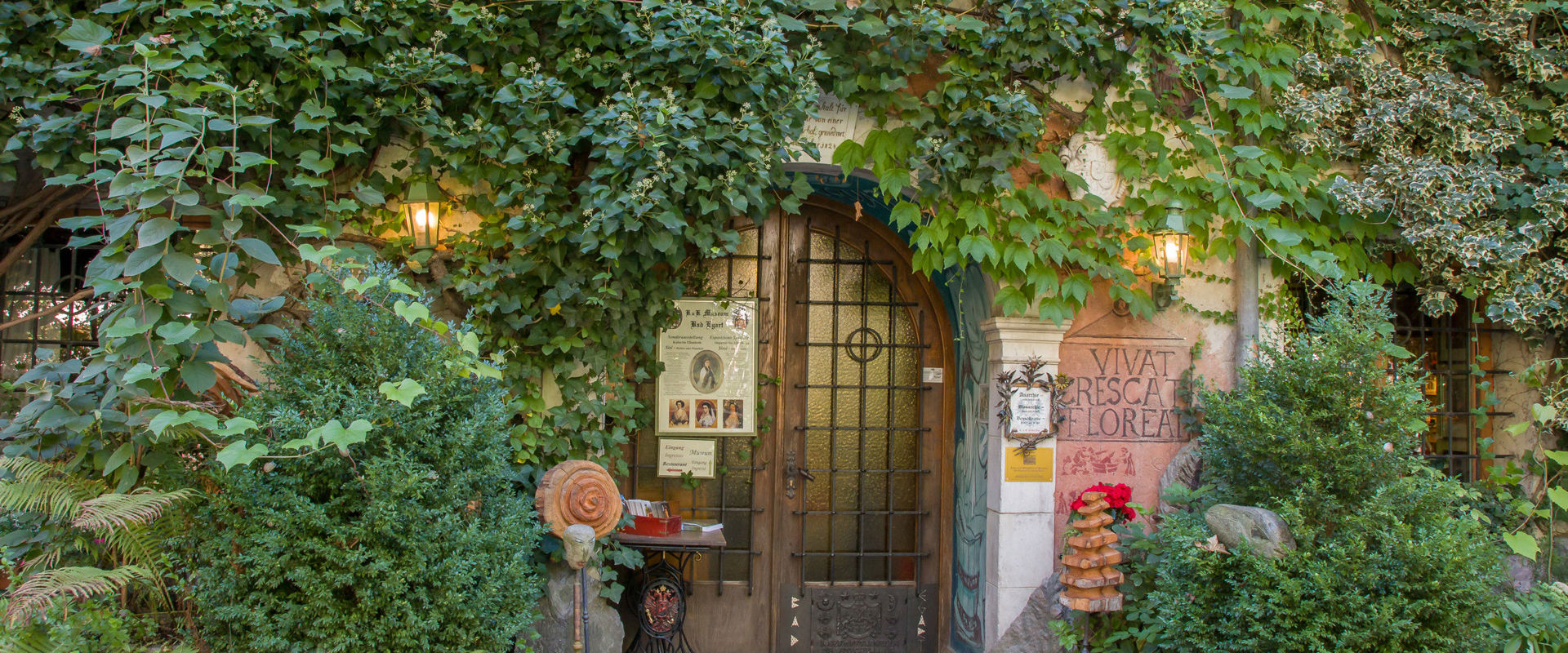 Entrance gate with ivy and flowers.