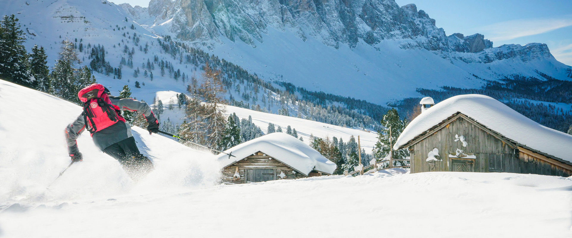 Villnöss Skier near mountain hut & Geisler Peaks in the snow