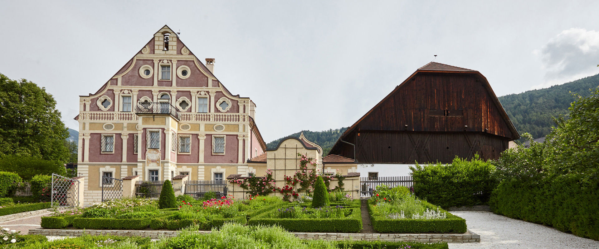 South Tyrolean Museum of Folklore Old beautiful house and farm next to it in the middle of the green.