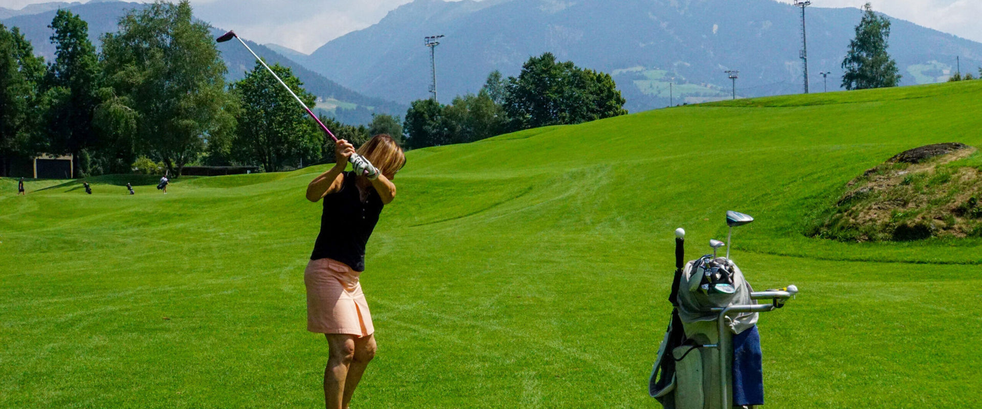 Woman at the golf course Woman standing on the golf course ready to shoot.