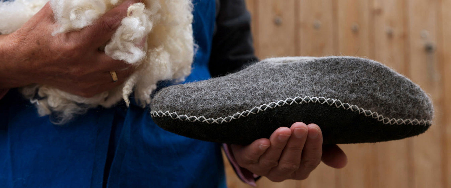 Felt slipper Man holding a felt slipper and wool.