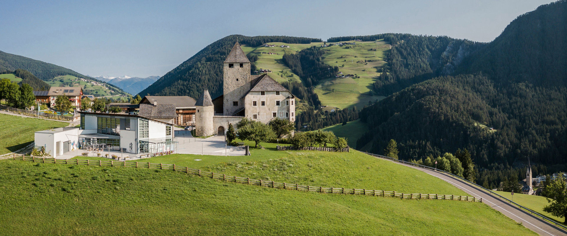 Museum Ladin Ćiastel de Tor Sight of a well-preserved castle in the middle of the green landscape.