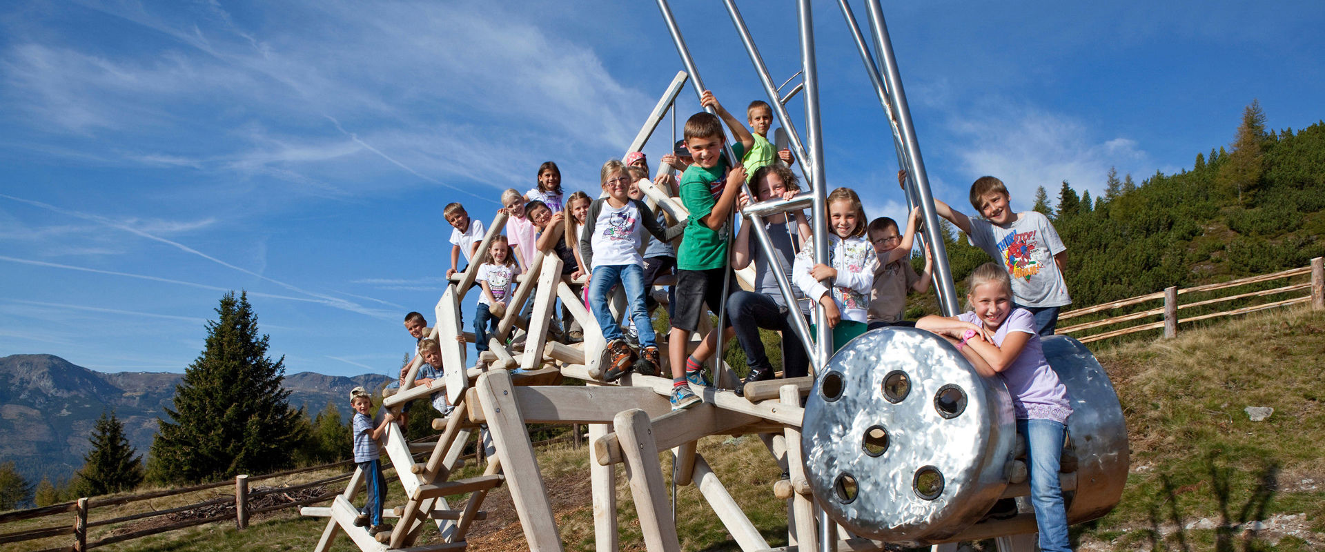 Nature experience “Urlesteig” path Children on a wooden animal scaffold.