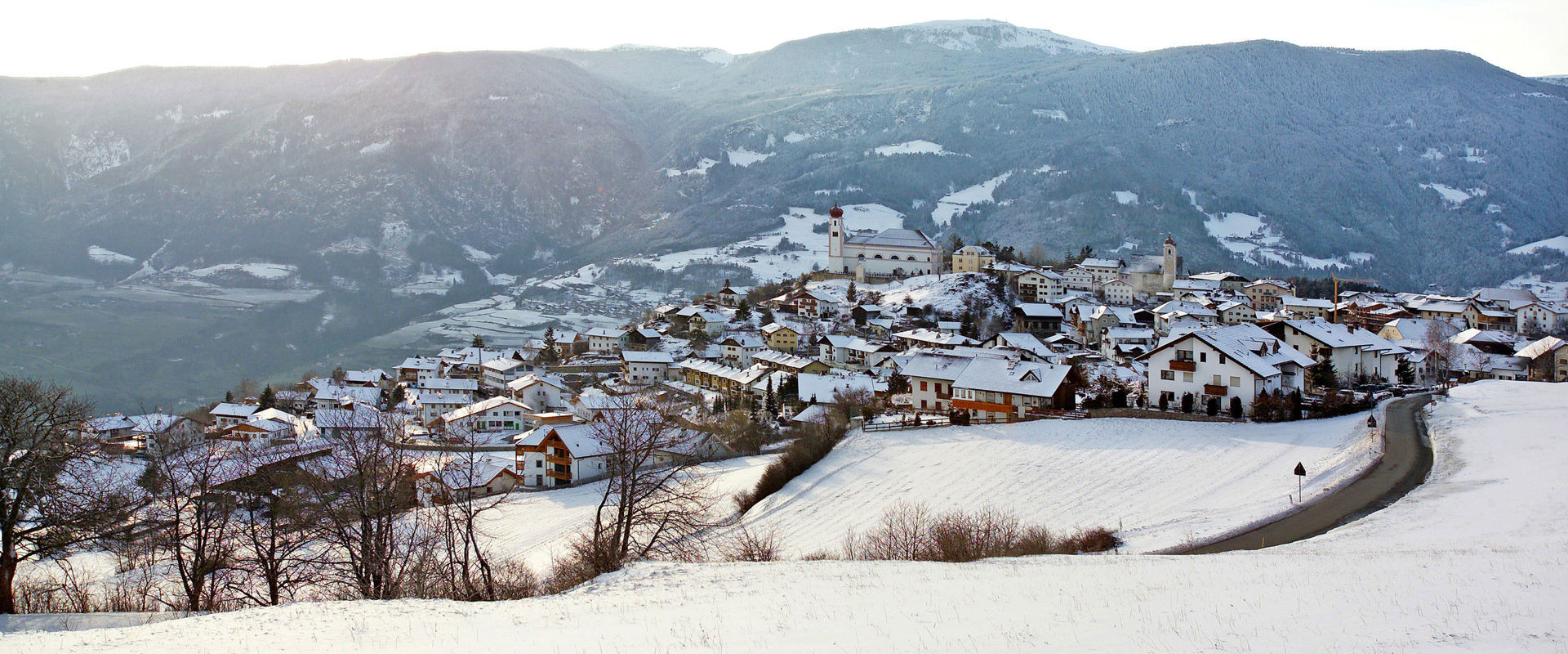 View of the snow-covered village of Lajen in winter