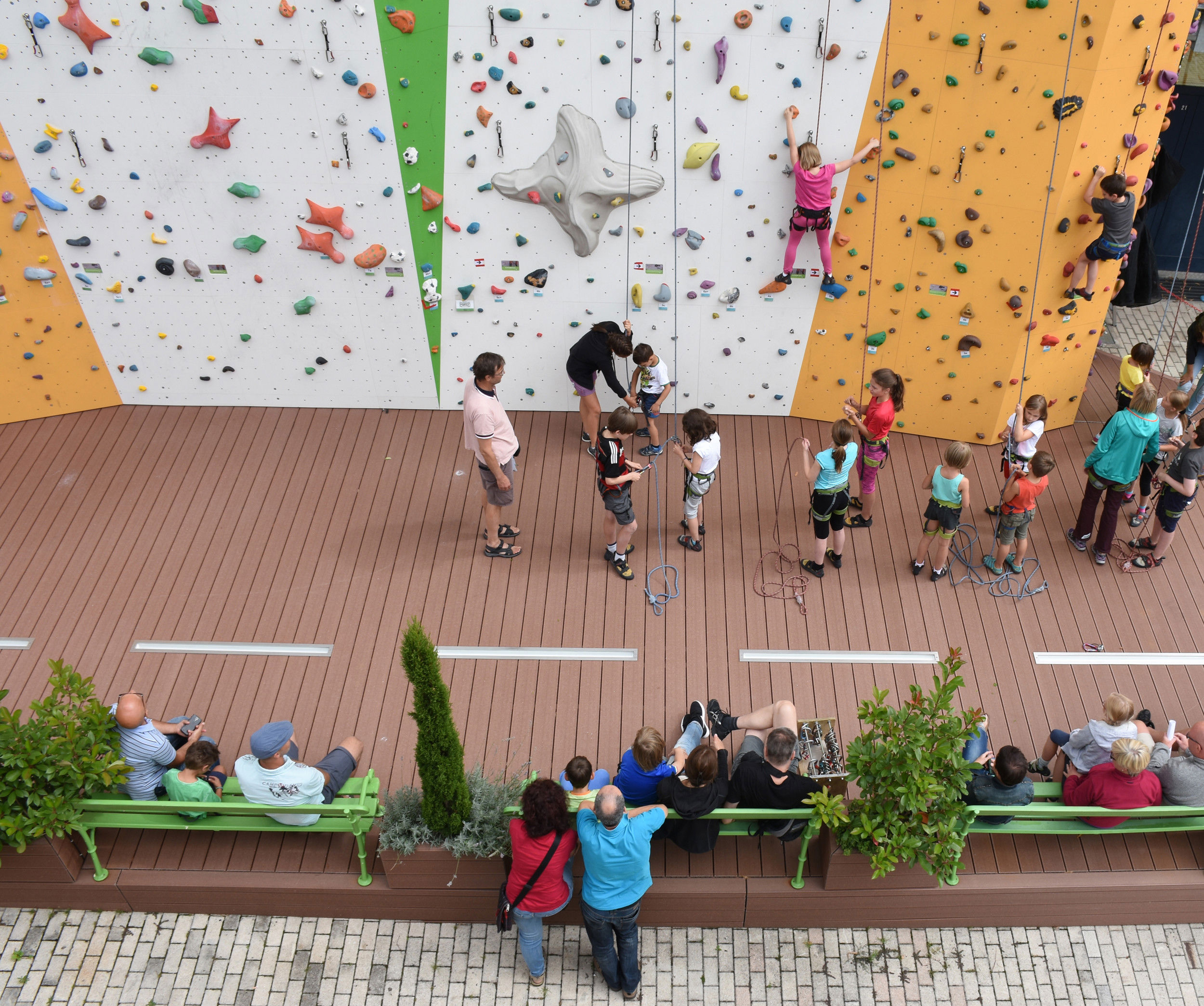 Children climbing outdoors in the Meran climbing centre.
