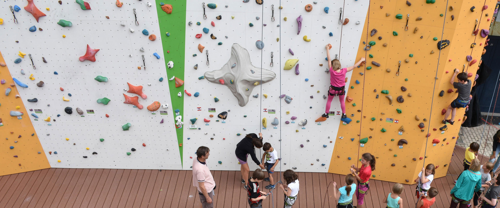 Climbing hall Rockarena Meran Children climbing outdoors in the Meran climbing centre.