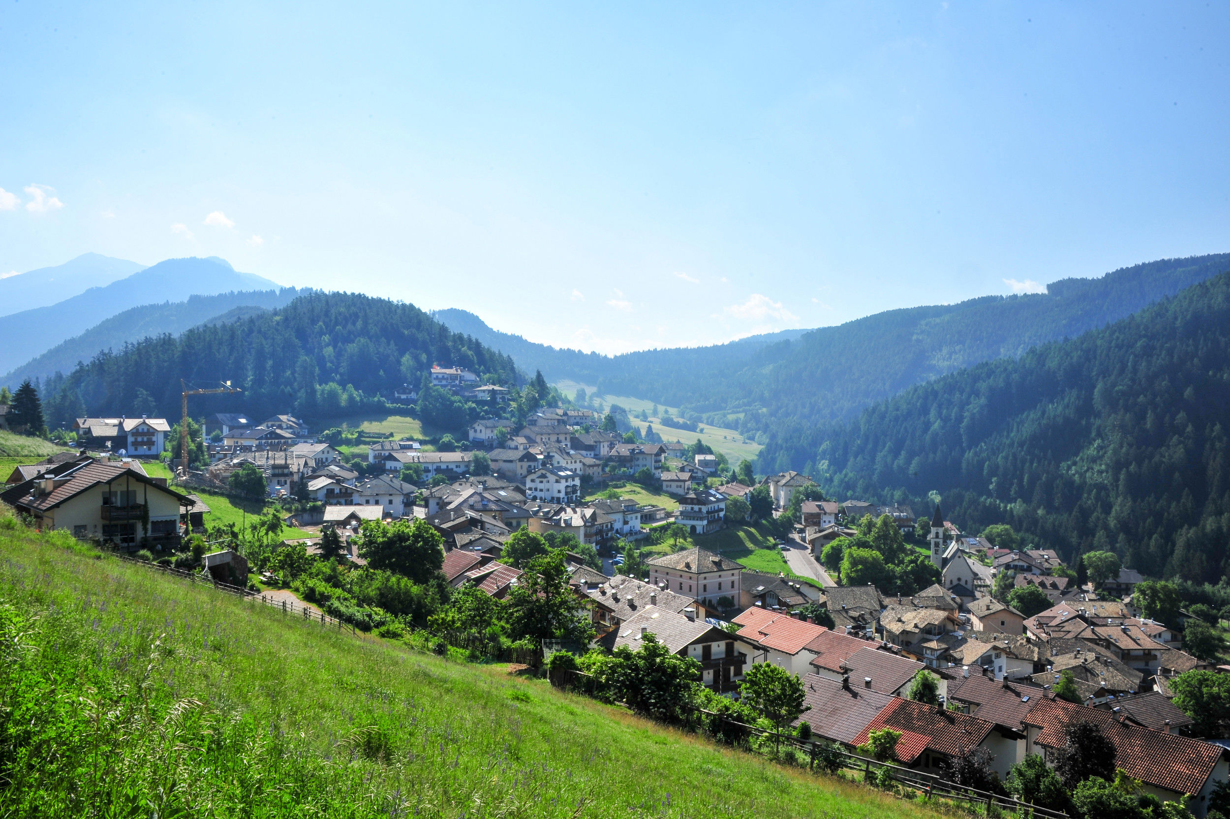 View of Trunden nestled in a gently rolling landscape and surrounded by dense forests.