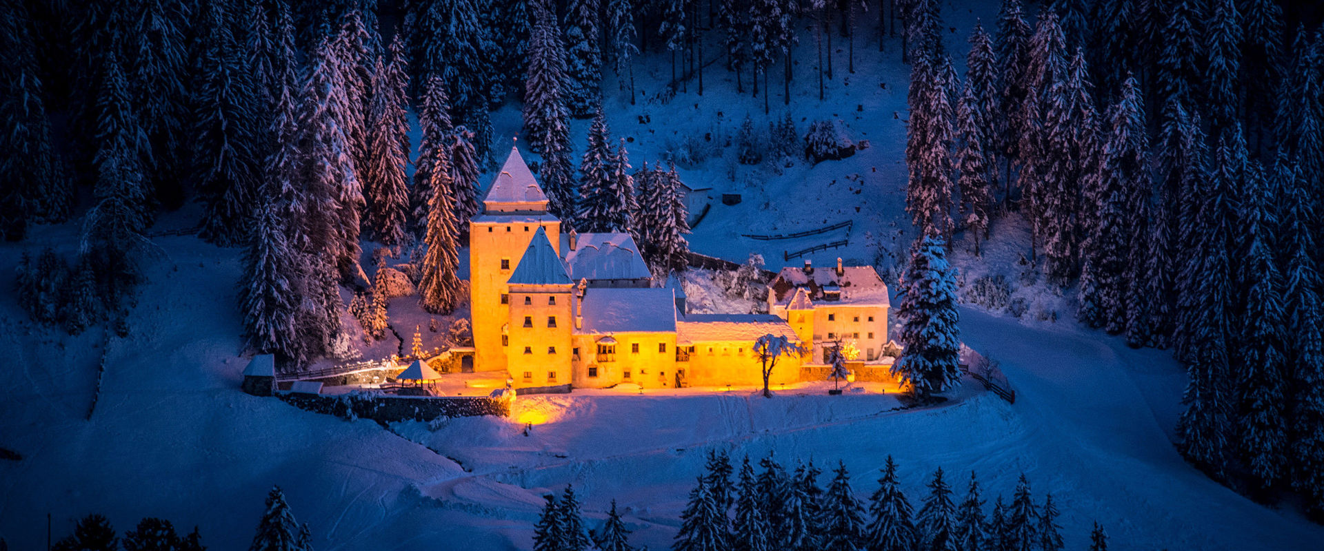 The Fish Castle in winter In the evening, in a clearing in the middle of the forest, you can see the snow-covered Fish Castle illuminated from below.