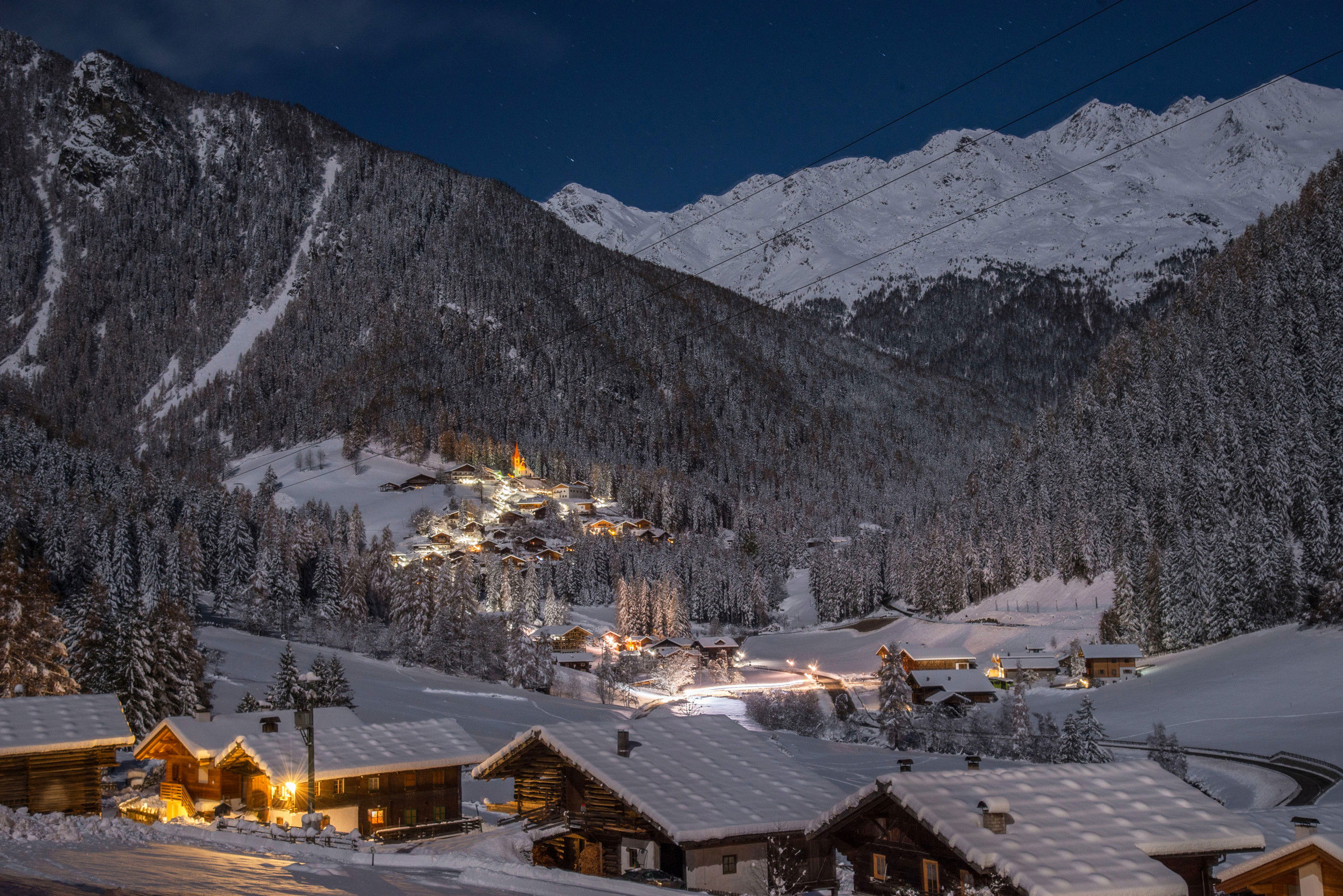 The village of St. Gertraud at night, covered with snow in the deepest of winter