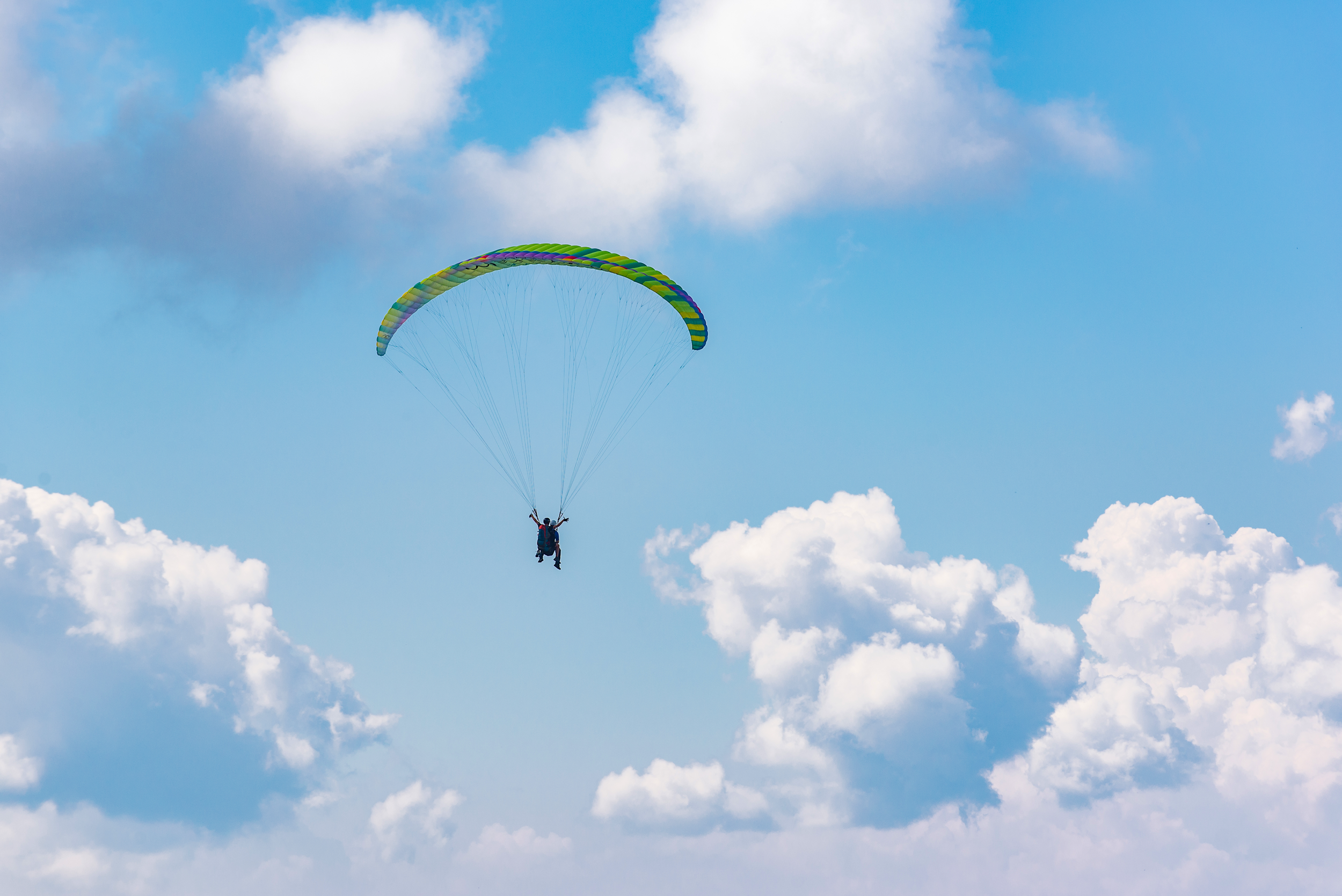 Paragliding at dawn in the clouds.