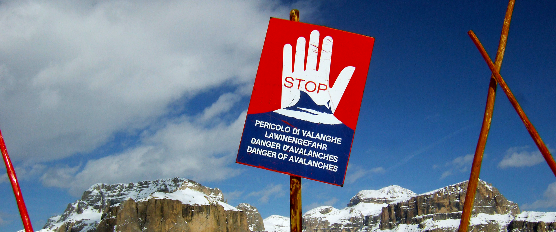 STOP danger of avalanches STOP sign, danger of avalanches in snow-covered landscape.