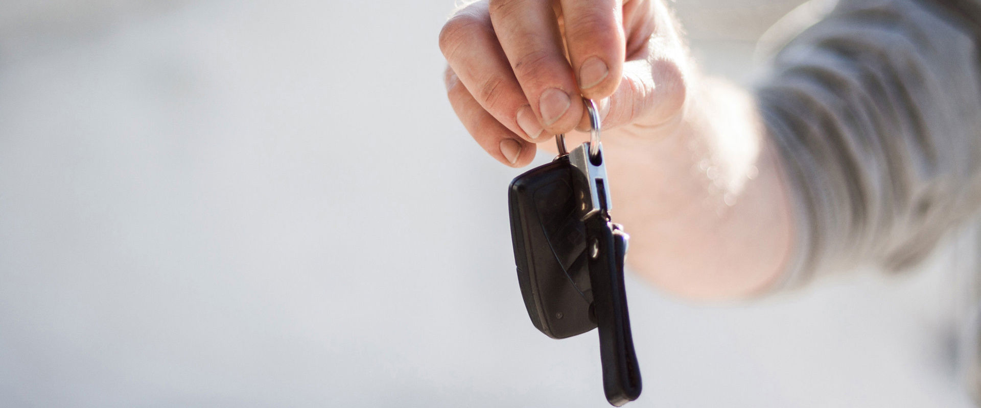 Car rental Man holding car keys in his hand.