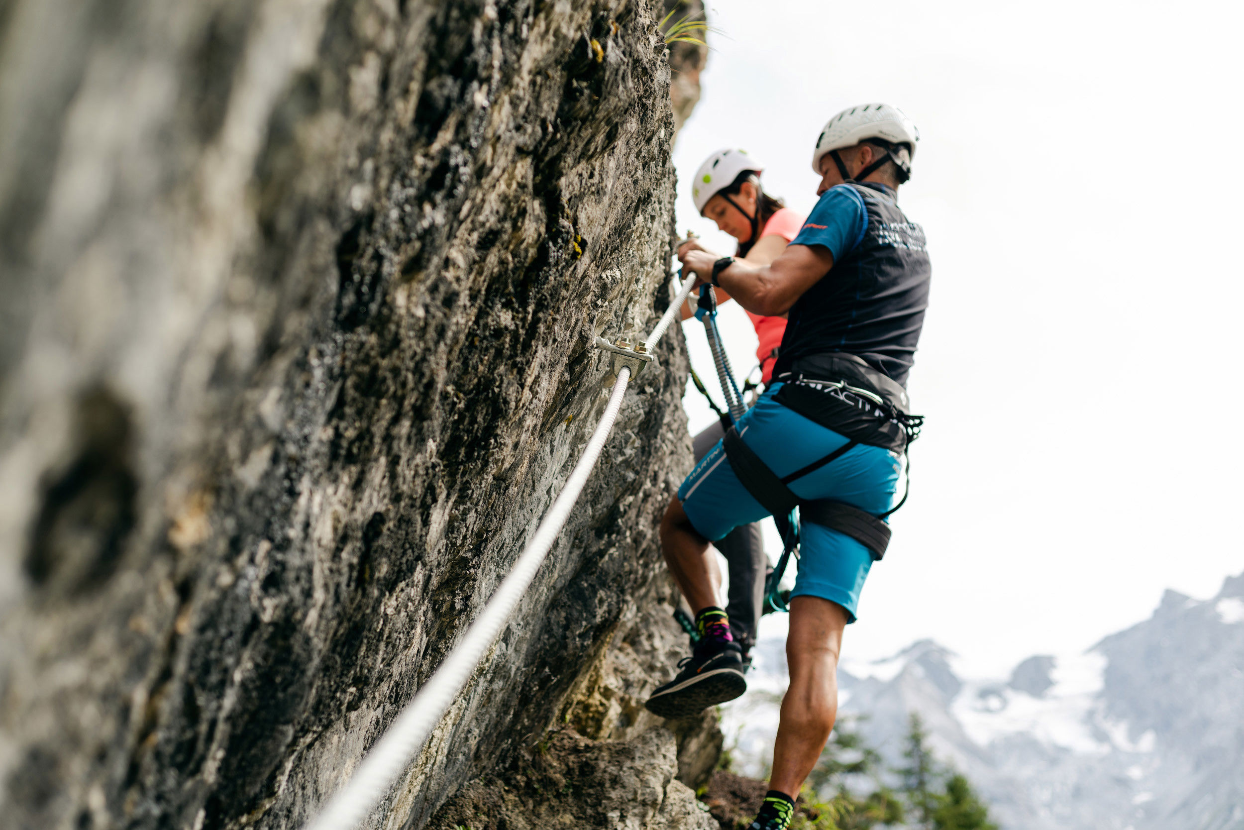 A man and a woman walk up the via ferrata.