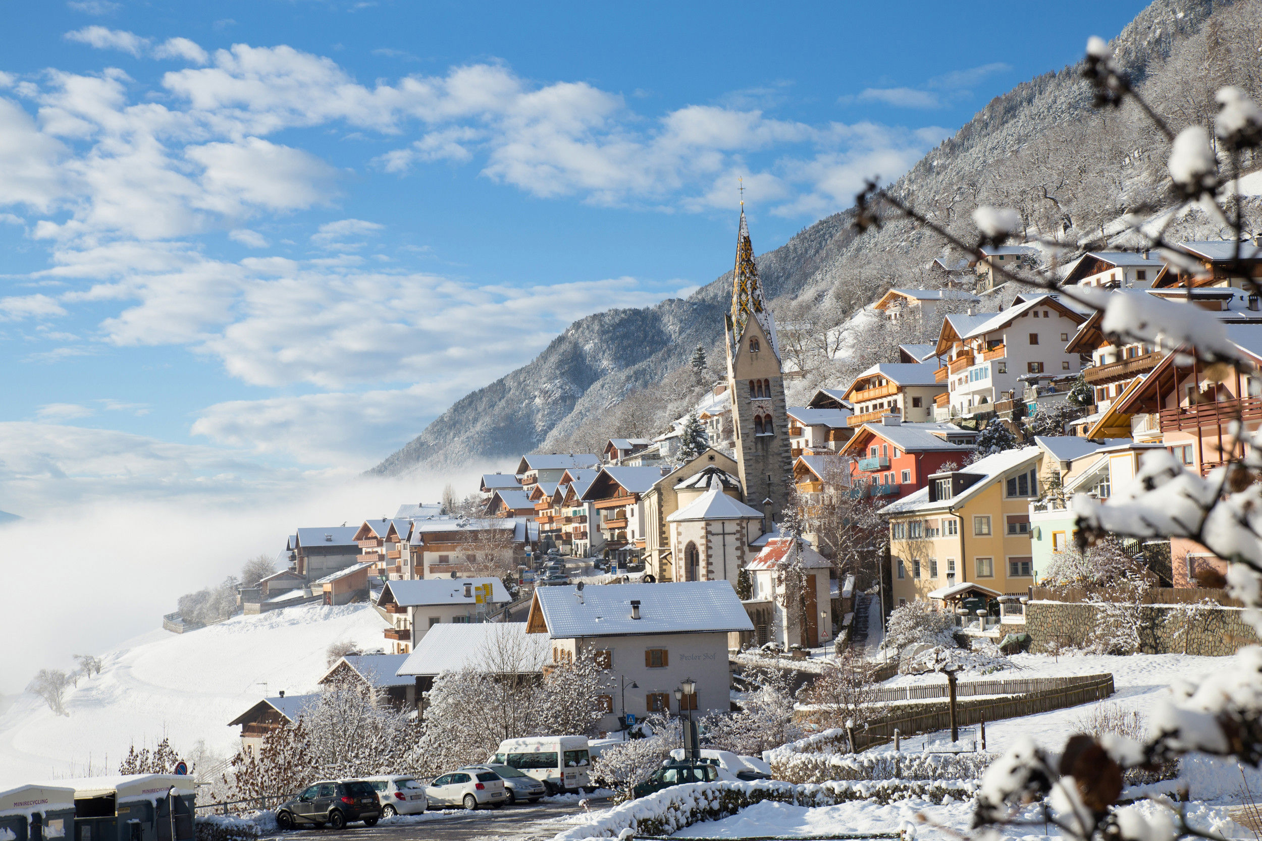 Snow-covered houses, church and hosues in Barbian