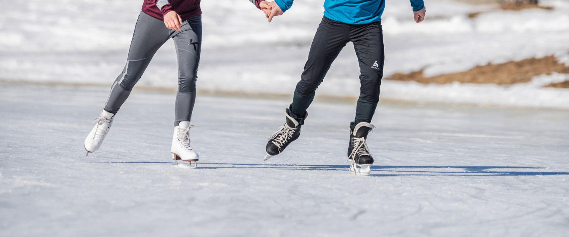 Young couple while ice-skating Young couple holding hands while ice-skating.