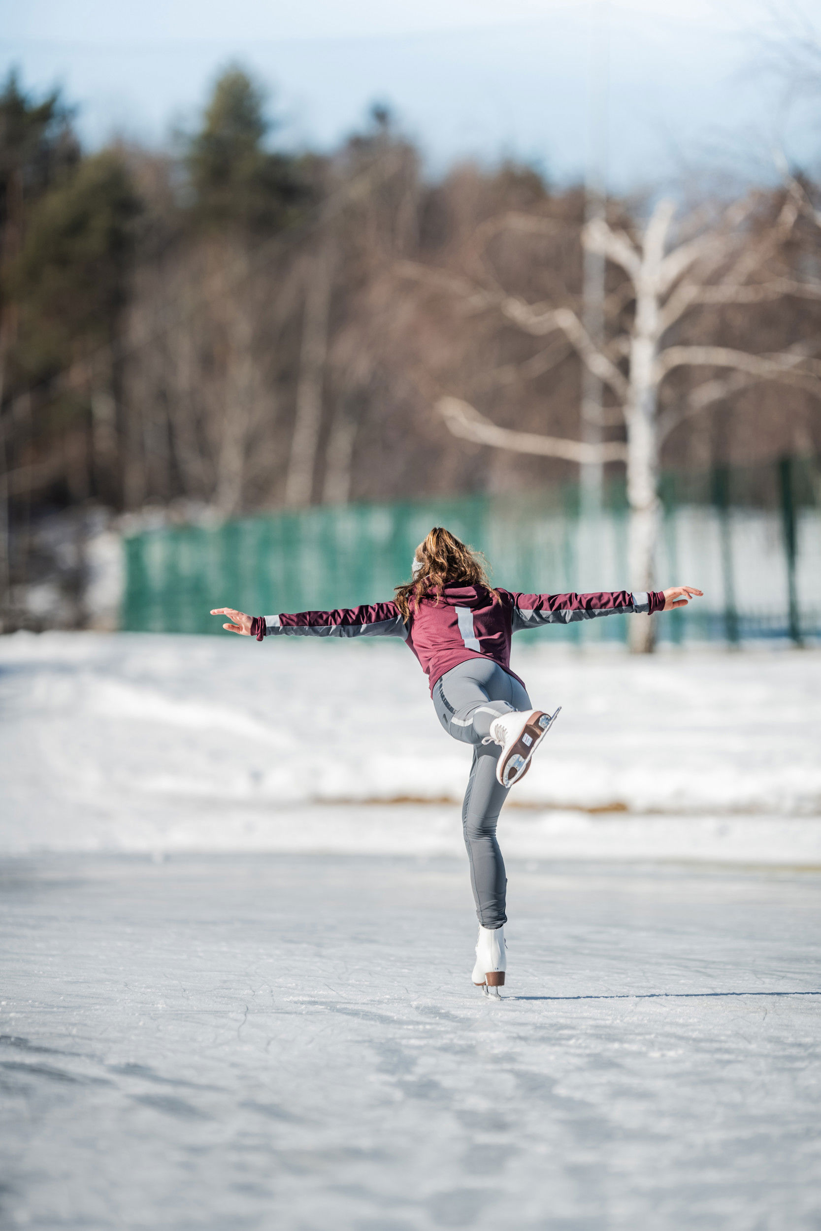 Figure skater on one leg. The other is extended backwards, the arms are at a 90 degree angle outwards.