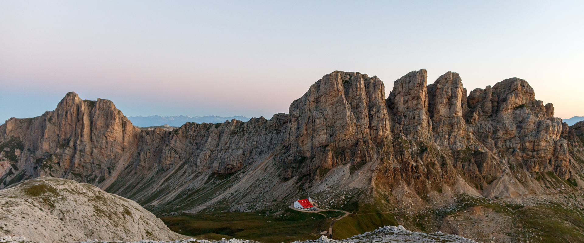 Tierser Alpl hut Small mountain hut with red roof in the Dolomite mountains