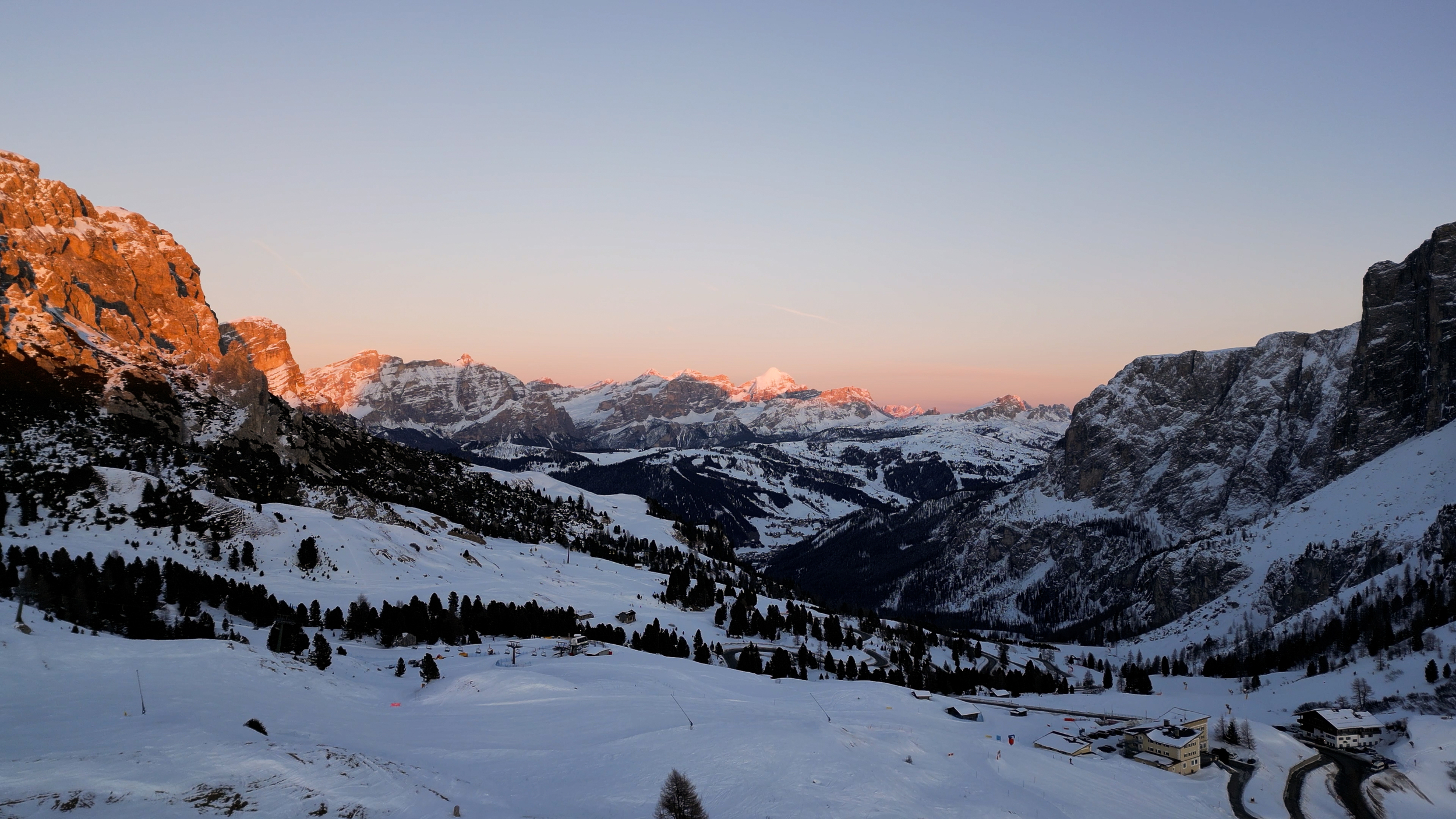 Sunset at the Grödner Joch Pass with a view of Kolfuschg in winter