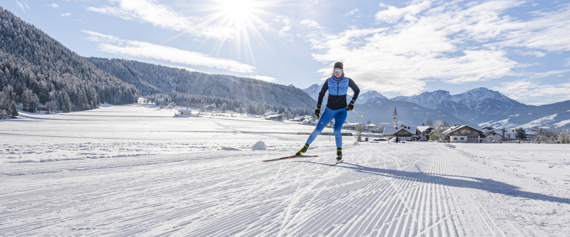 Cross-country skier enjoying the sport on the trail in glorious winter weather