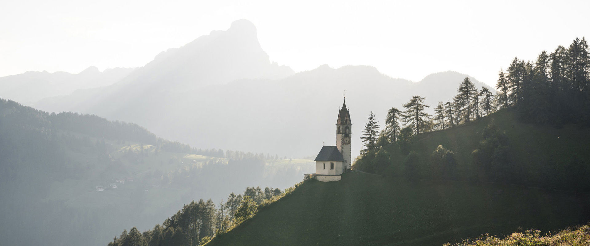 Small church Small church on a hill in the middle of the green landscape.