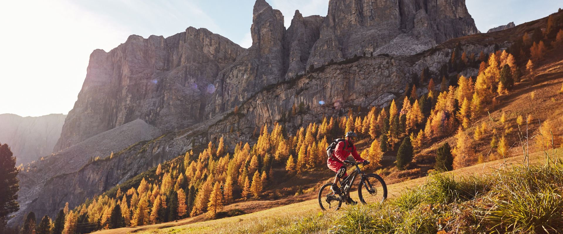 MTB at Grödner Joch Pass Mountain biker in an autumnal mountain landscape in the Dolomites