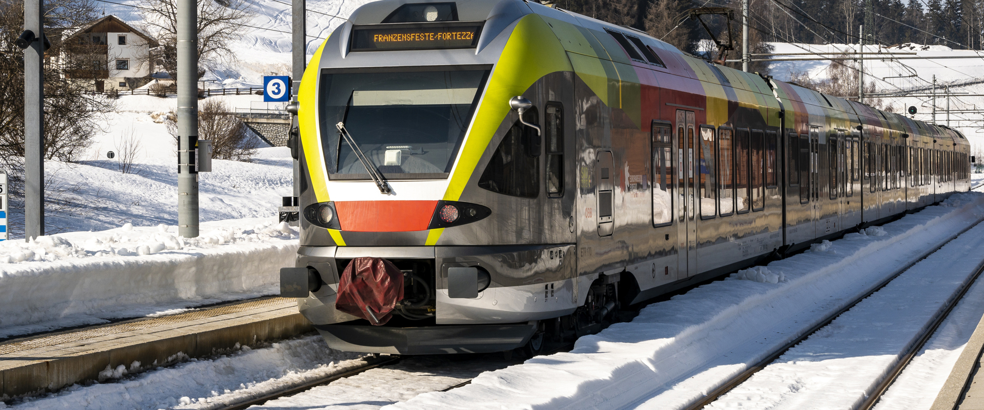 Train restrictions South Tyrol Colourful train standing on a snow-covered railway track