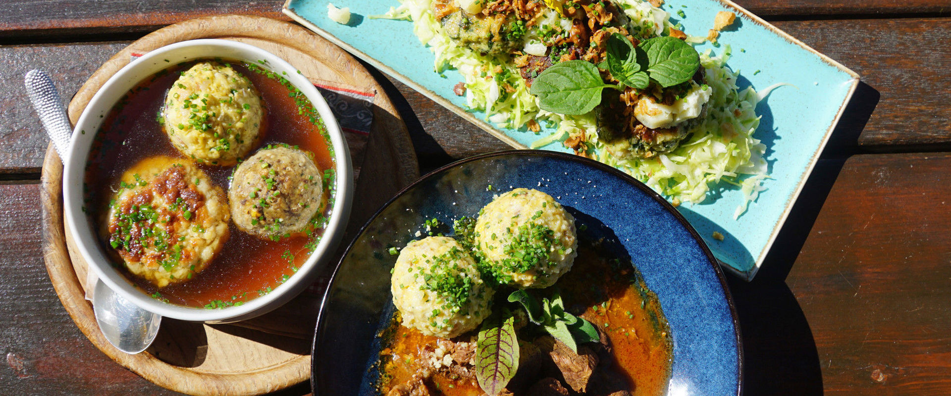 Three different plates with different dumpling dishes.