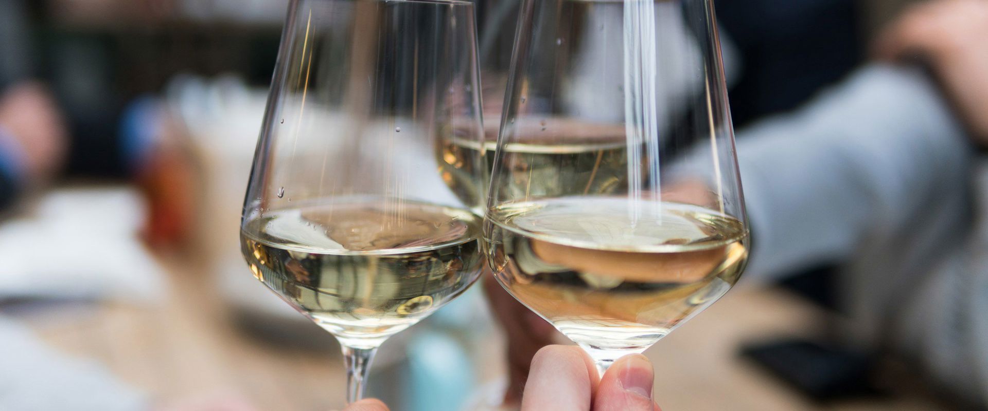White wines Friends toast together with a glass of wine.