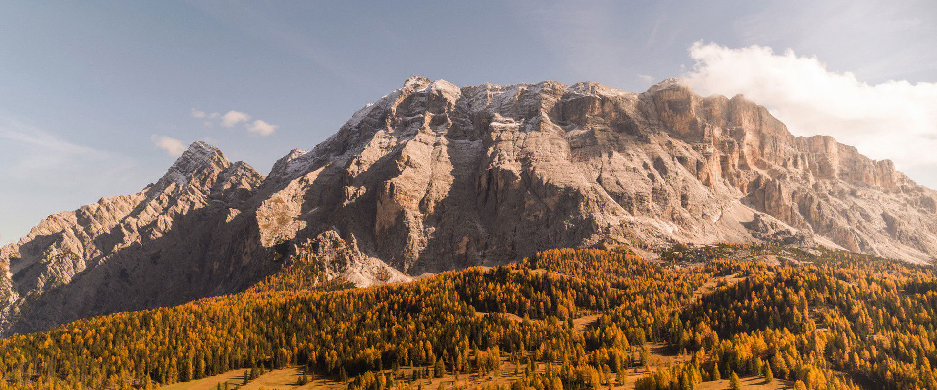 Mt. Heiligkreuzkofel and golden woods in autumn.